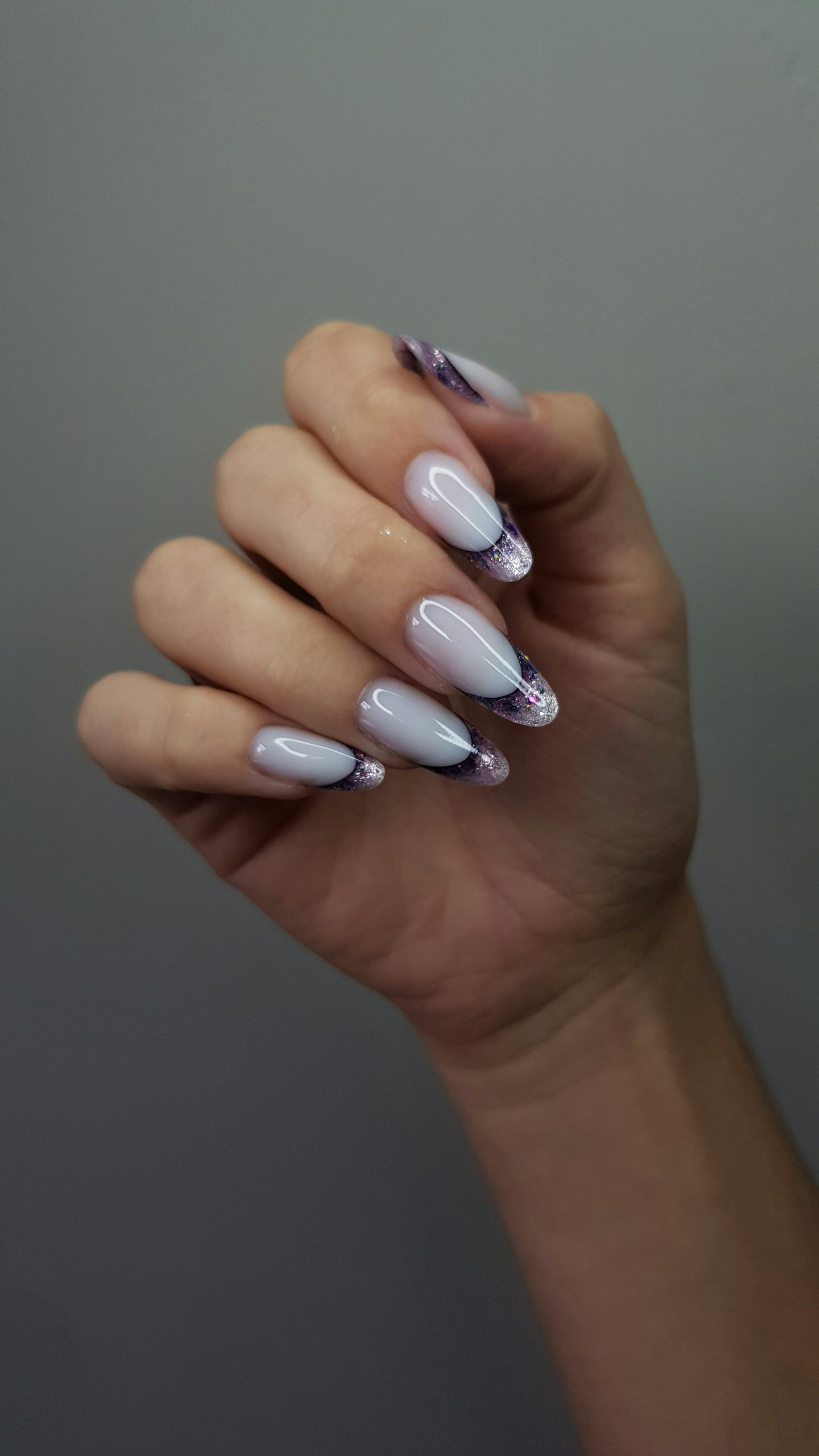 White nails with purple and black marbled tips
