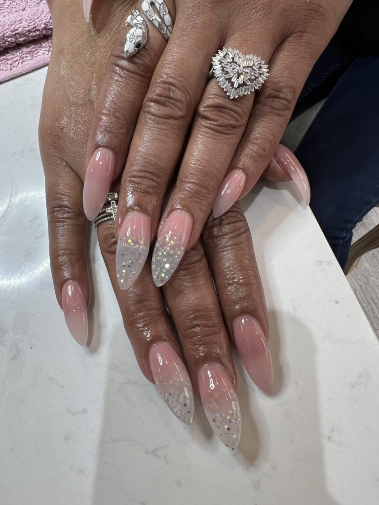 Long stiletto nails in soft pink with a silver glitter ombré