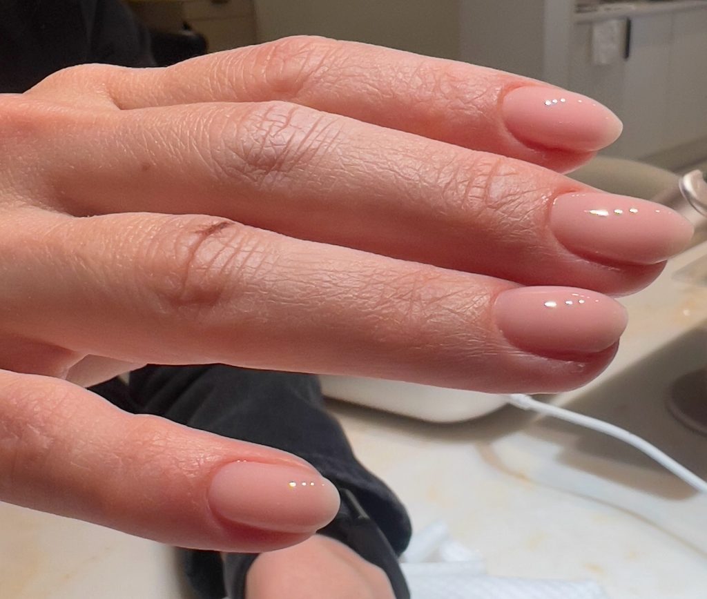 Sheer nude squoval nails with a glassy finish