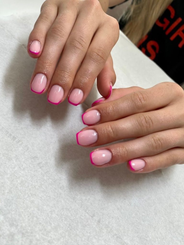 Soft pink nails outlined in hot pink